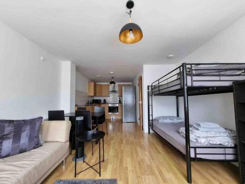 a living room with a couch and a bunk bed at Bright and cosy 1 bed flat next to Tower Bridge in London