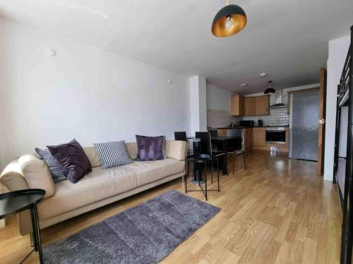a living room with a couch and a dining room at Bright and cosy 1 bed flat next to Tower Bridge in London