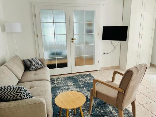 a living room with a couch and a table and a tv at Blue Horizon in Novi Vinodolski