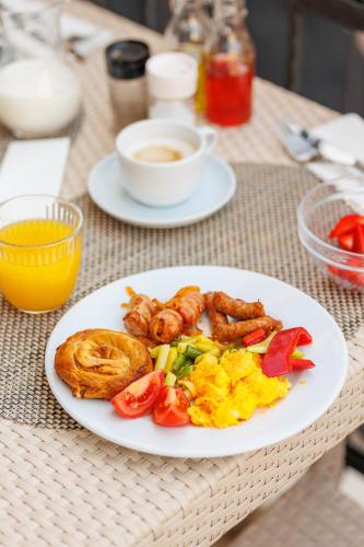 a plate of breakfast food on a table at Hotel Kadmo by Aycon in Budva
