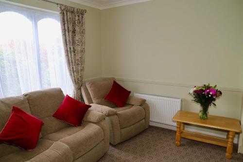 a living room with a couch and a vase of flowers at Centrally located house on Ring of Kerry in Killorglin
