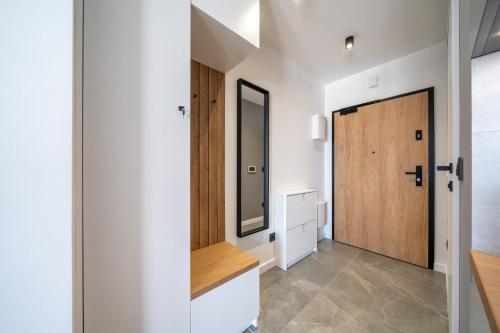 a hallway with a wooden door in a house at Verona House Apartment in Krakow