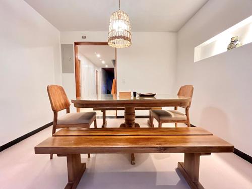 a dining room with a wooden table and chairs at Casa ALOHA 152 in Bogotá