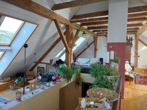 a large living room with wooden ceilings and windows at Romantik-Villa LebensART in Reichenfels