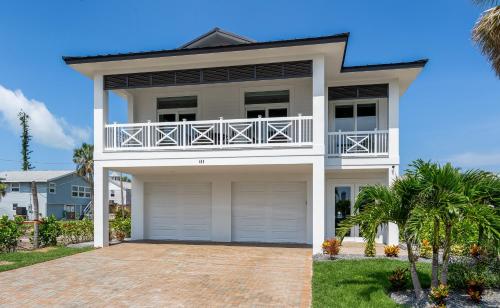a large white house with a balcony at Beautiful New Build - 450 Palermo home in Fort Myers Beach