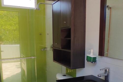 a bathroom with a sink and a glass shower at Ayenda Casa 12 in Santa Marta