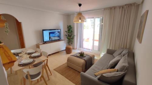 a living room with a couch and a table at Heydays Apartment in La Mata