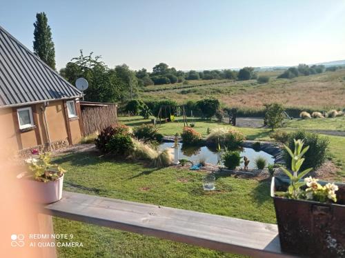 a view of a garden from the balcony of a house at Gîte du roy in Marais-Vernier