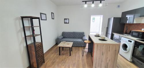 a kitchen with a couch and a table in a room at The Luxe Flat No 4, Mansfield, in Mansfield