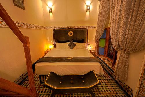 a bedroom with a large bed in a room at Riad Sahraui in Fès