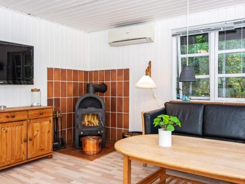 a living room with a couch and a fireplace at 6 person holiday home in Ulfborg-By Traum in Ulfborg