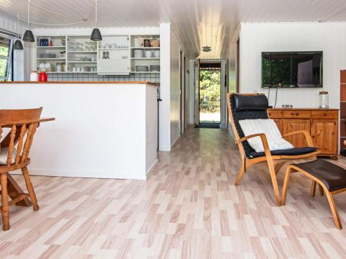 a kitchen and living room with a counter and chairs at 6 person holiday home in Ulfborg-By Traum in Ulfborg