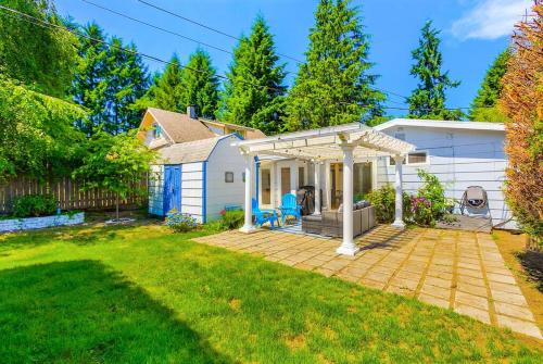 a white house with a gazebo in a yard at Bodur's Nest Whispering Garden in Tacoma