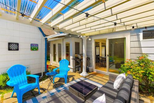a patio with two blue chairs and a couch at Bodur's Nest Whispering Garden in Tacoma