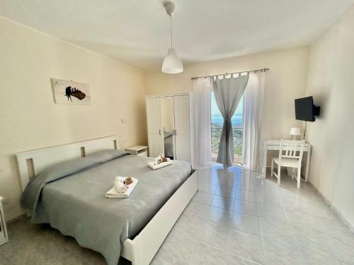 a bedroom with a bed and a desk and a window at Il Nido delle Rondini in Formia