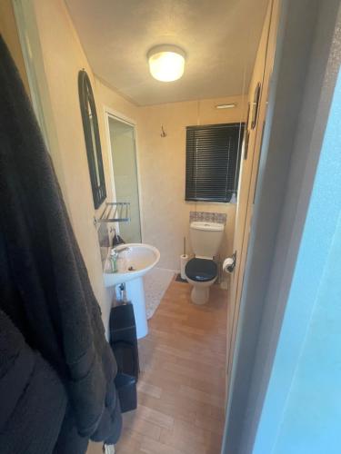 a small bathroom with a toilet and a sink at Shear water in Morecambe