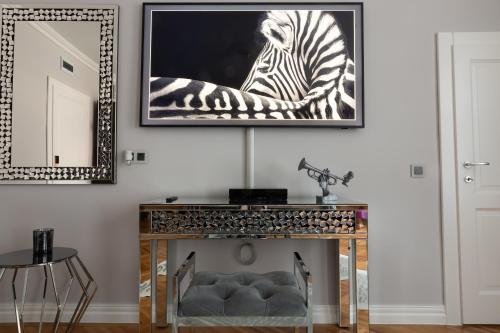 a living room with a picture of a zebra on the wall at Fancy Flats in Sibiu