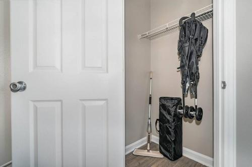 a door with a bunch of hockey equipment in a room at King Beds 2- Smart TVs-Free Parking-Patio in Greensboro