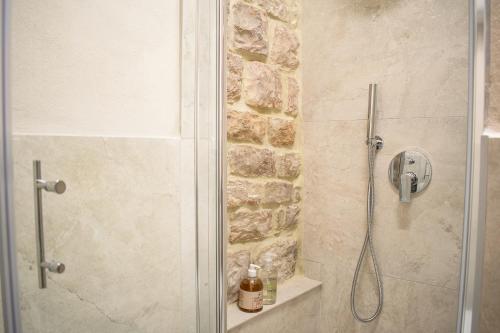 a shower with a glass door in a bathroom at Monolocale centro storico in Gubbio
