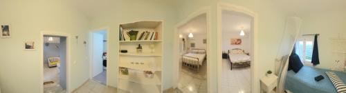 Dieses weiße Zimmer verfügt über ein Schlafzimmer und ein Badezimmer. in der Unterkunft Charming house with stunning view in Arvanitakaíïka