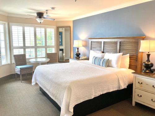 a bedroom with a large bed with a blue wall at Sand Pebbles Inn in Cambria