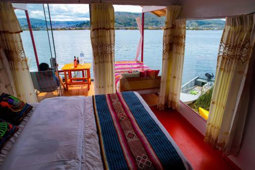 a bedroom on a boat with a view of the water at Lake View Lodge in Puno