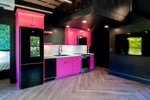 a kitchen with pink cabinets and a sink at The 505 Eugene in Eugene