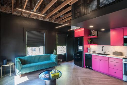 a kitchen with a blue couch and pink cabinets at The 505 Eugene in Eugene