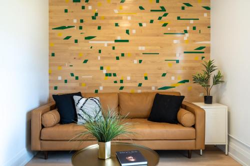 a living room with a brown couch and a wooden wall at The 505 Eugene in Eugene