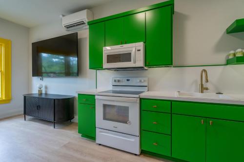 a kitchen with green cabinets and a microwave at The 505 Eugene in Eugene