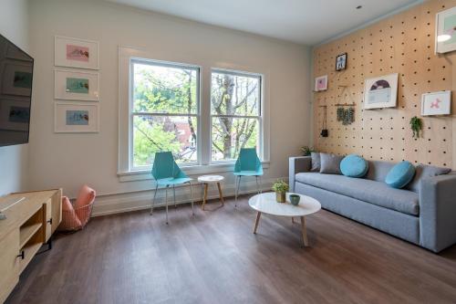 a living room with a blue couch and chairs at The 505 Eugene in Eugene