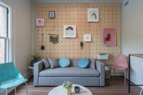 a living room with a couch and a wall with pictures at The 505 Eugene in Eugene