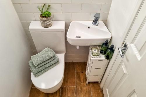a small bathroom with a toilet and a sink at The Bs Cycle, 4 Bedroom, 2 Bathroom, House in Harrogate Centre in Harrogate