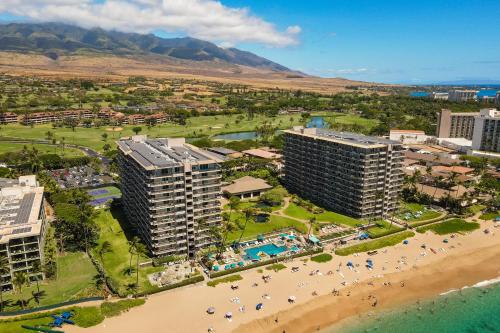 an aerial view of a resort with a beach and buildings at The Whaler Resort in Lahaina