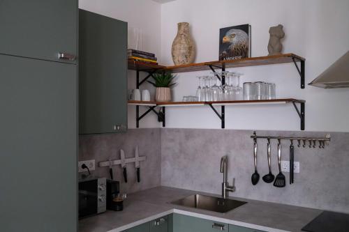 a kitchen with a sink and a counter with utensils at Cityscape Apartment ~ AC/Indoor parking/Balcony in Budapest