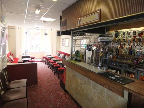 a bar with a row of chairs and a counter at Charnley Gold in Blackpool