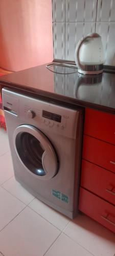 a washing machine in a kitchen with a counter at Cozy apartment in Sevan City in Sevan
