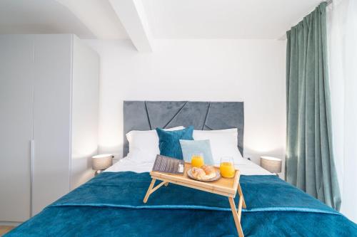 a bedroom with a bed with a tray of food on it at Luxury Villa Salt in Slano