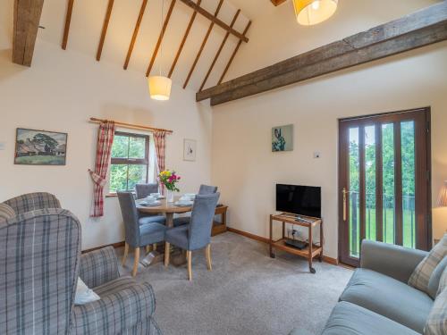 a living room with a table and chairs and a tv at The Granary - Uk44490 in Sedgefield