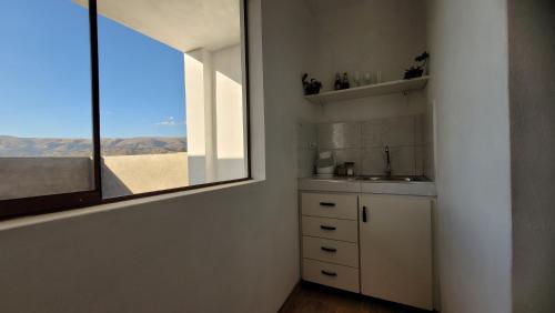 a kitchen with a sink and a window with a view at Apartment with amazing view in Huancayo