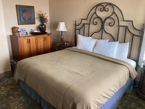 a hotel room with a large bed with white pillows at Blue Dolphin Inn in Cambria