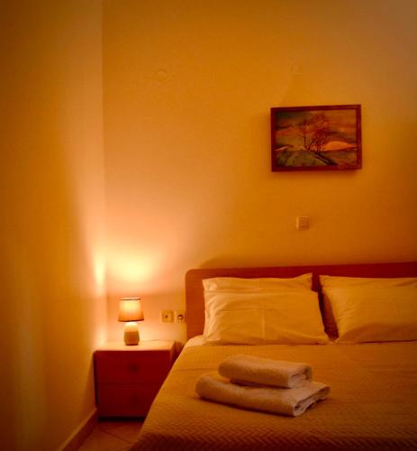 a bedroom with a bed with two towels on it at Nik apartment in Ierapetra