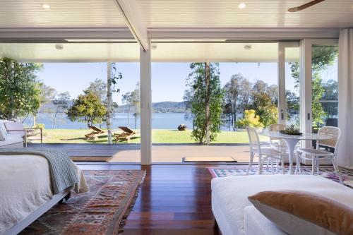 a bedroom with a view of the water at The Moorings Lakehouse in Whoota