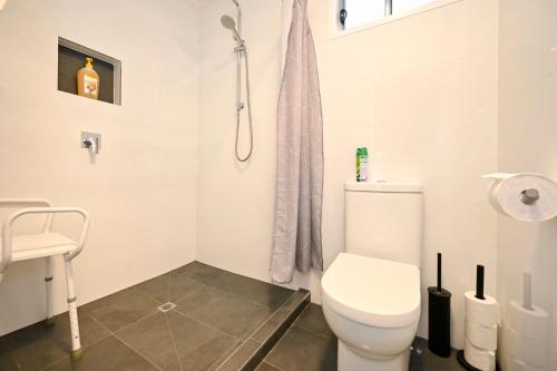 a white bathroom with a toilet and a sink at Stylish 2 b/r apartment - 4 guests, garage ZC5 in Alexandra Headland