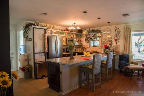 a kitchen with a refrigerator and a table with chairs at La Villetta in Dripping Springs