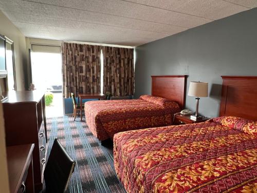 a hotel room with two beds and a window at Royal Inn Motel-Charlottesville in Charlottesville