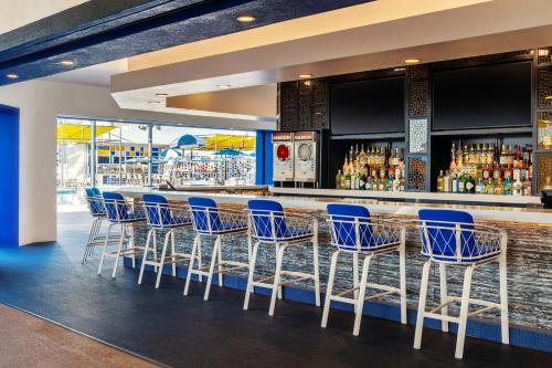 a bar with blue chairs and a counter at The STRAT Hotel, Casino & Tower in Las Vegas