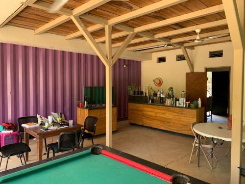 a living room with a pool table and a bar at EL TUMBO in Rivas