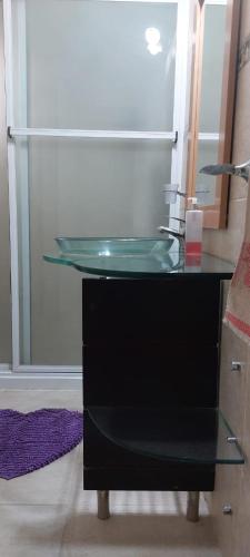 a glass sink in front of a refrigerator at MAPU PATAGONIA in Puerto Madryn