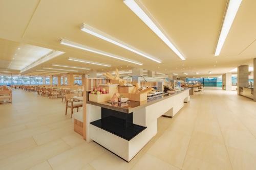 a restaurant with a counter and tables and chairs at Barceló Maya Riviera - All Inclusive Adults Only in Xpu Ha